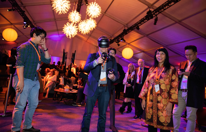 Event guest using virtual reality technology at Forever Orange campaign event